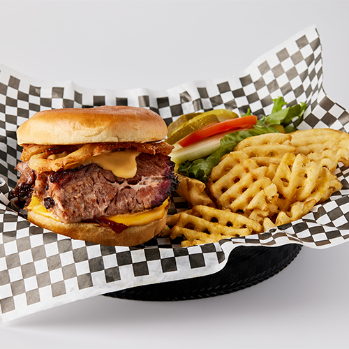 A hamburger and fries are in a basket.