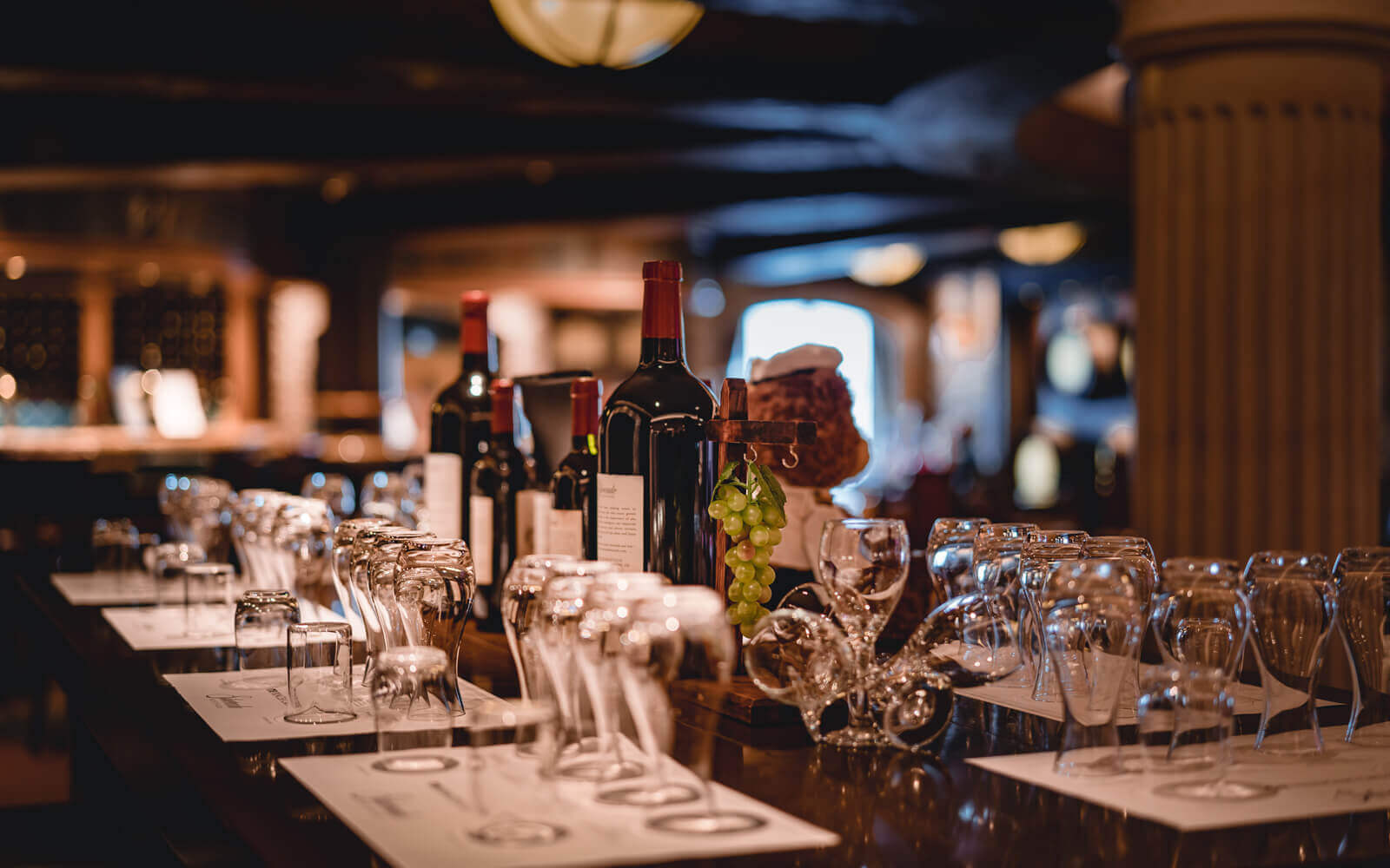 A table with wine bottles and glasses on it